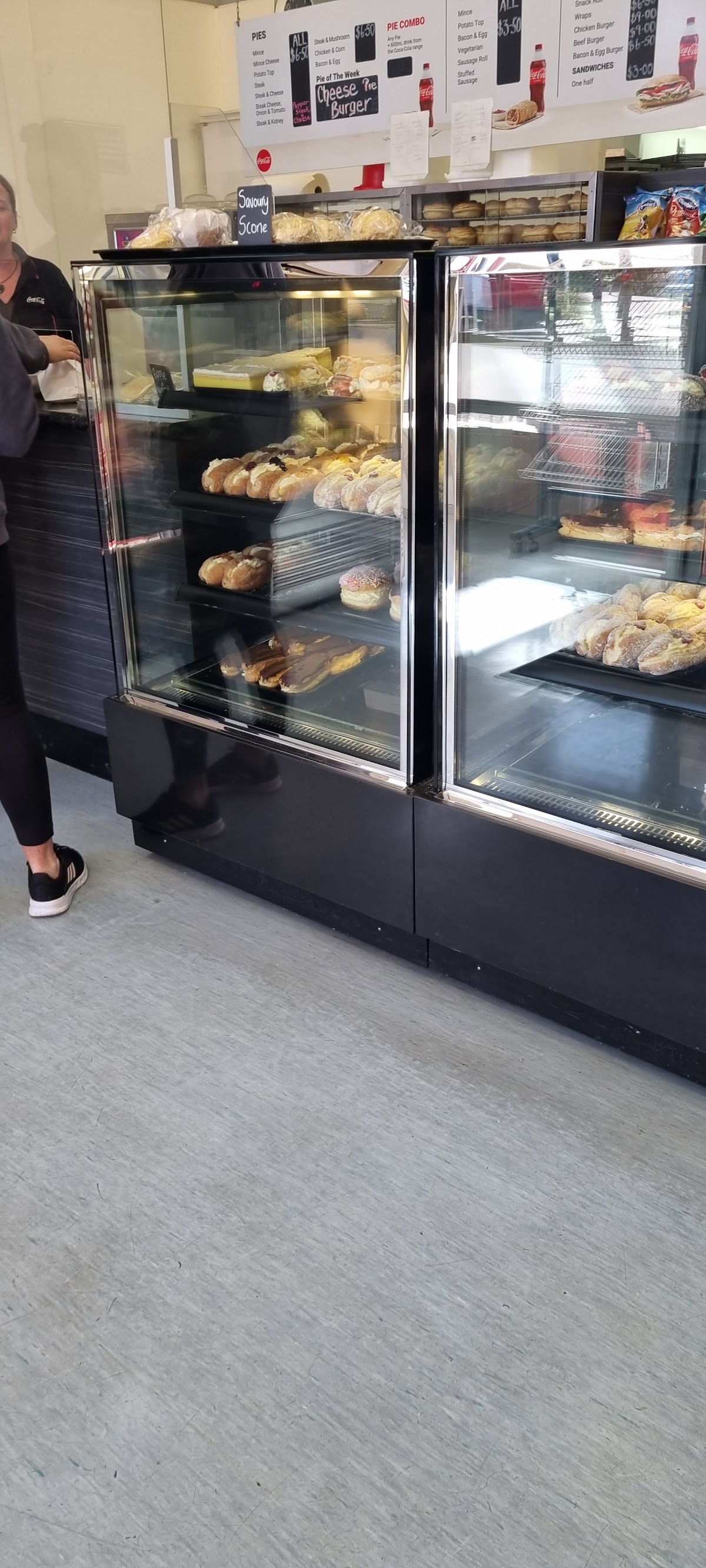 Inside Beresford Bakery, the display cabinet and menu board